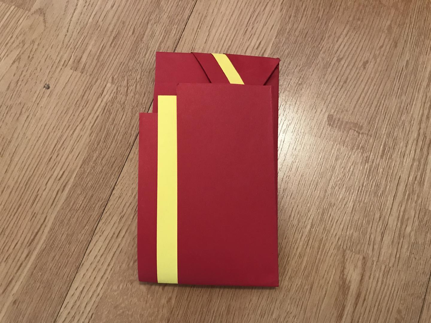 The short edge is tucked into the opening at the other end to create an envelope