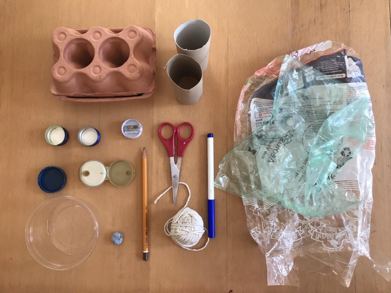 2 loo rolls, Plastic packaging, string, Pen, Pencil and sharpener, Scissors, Plastic bottle tops, Egg box, Blue tac