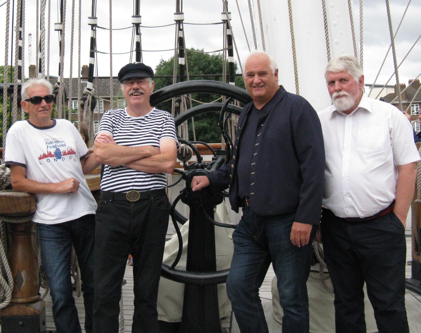 A group photo of sea shanty singers Swinging the Lead on board Cutty Sark