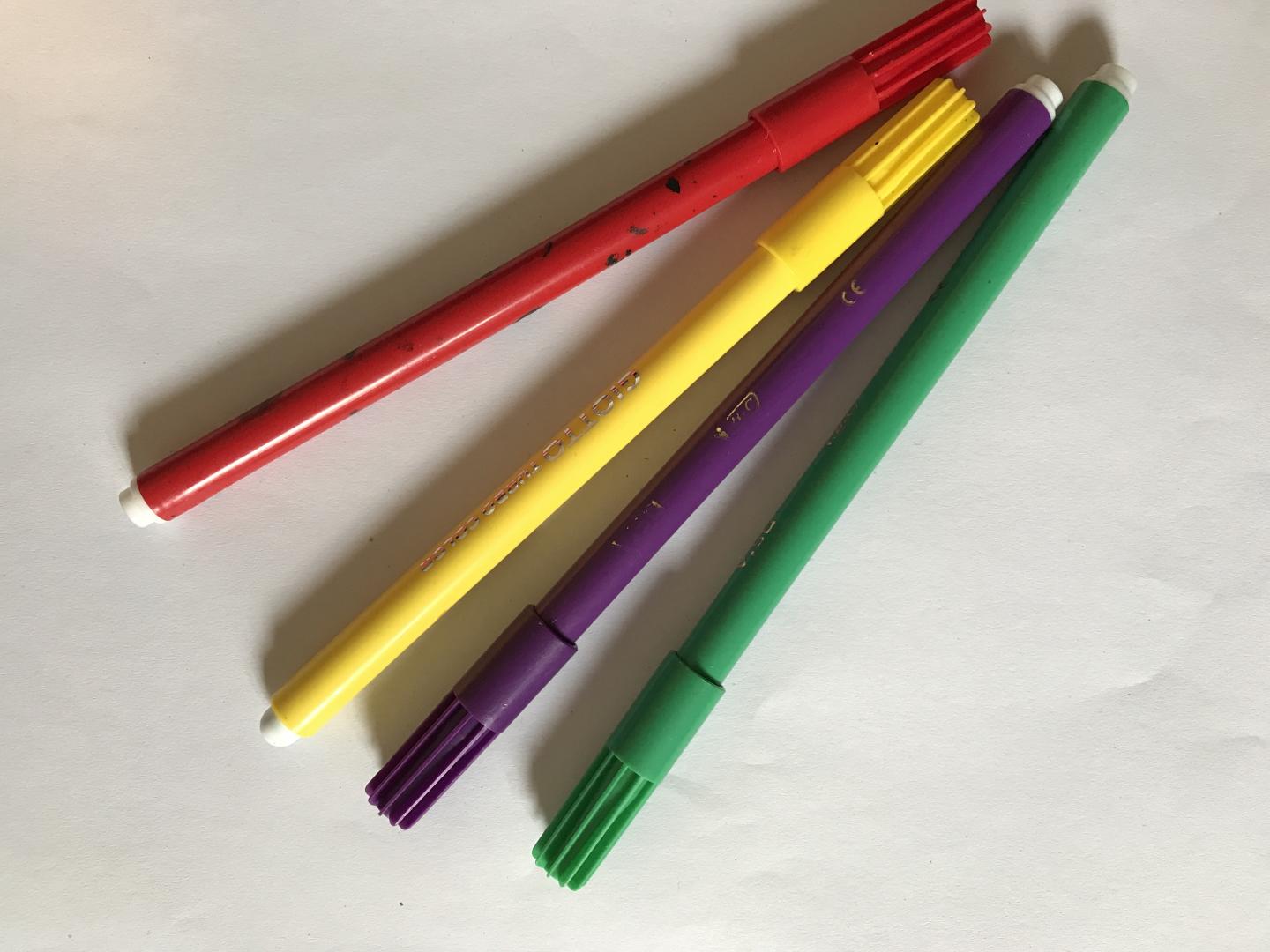 A red, yellow, purple and green felt tip pen.