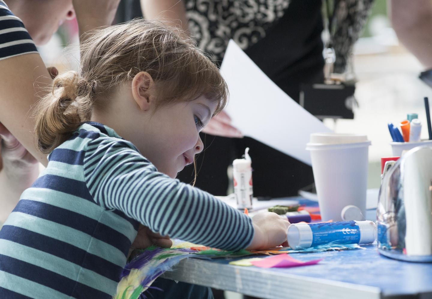 Child participating in craft activity.