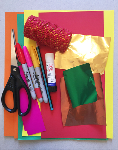 bright coloured paper including metallic paper, scissors, red string, glue stick, pencil, coloured pens