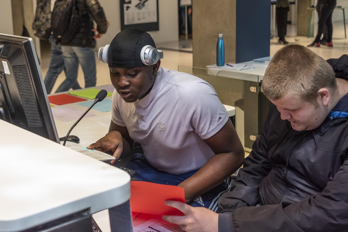 Two young people are reading out loud over the Tannoy System in the museum as part of the Tannoy Takeover