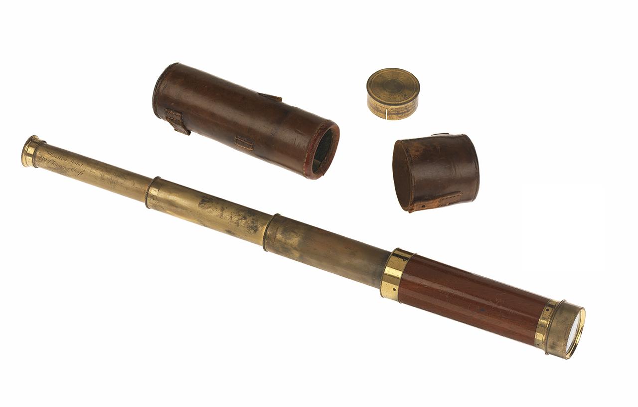 A brown and gold extendable pocket telescope with brown leather case