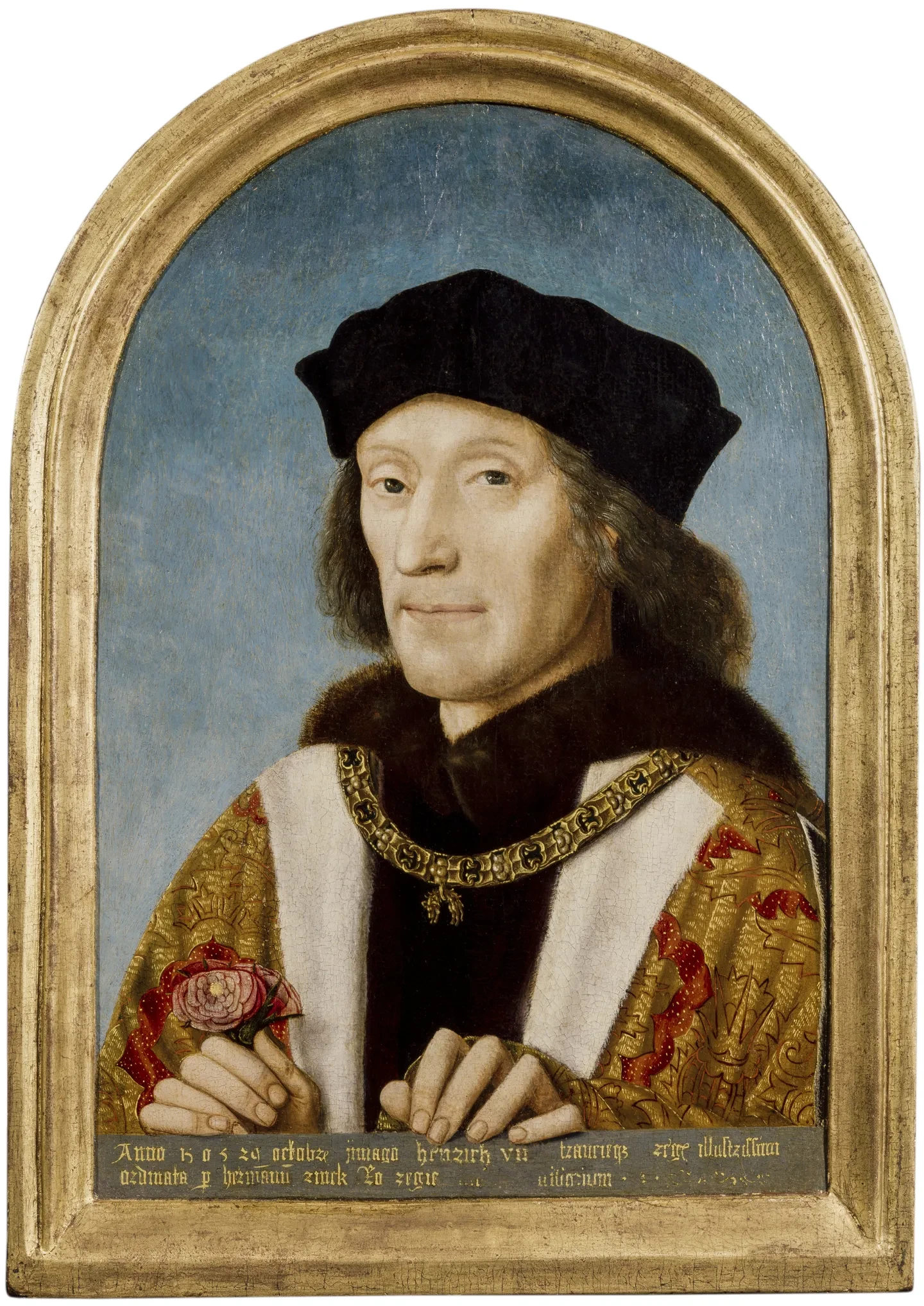 Henry VII wears a gold robe with a gold chain