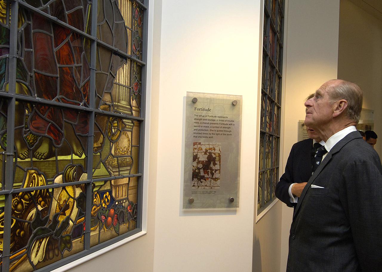 Prince Philip visits the National Maritime Museum and looks at a stained glass window named 'Fortitude'