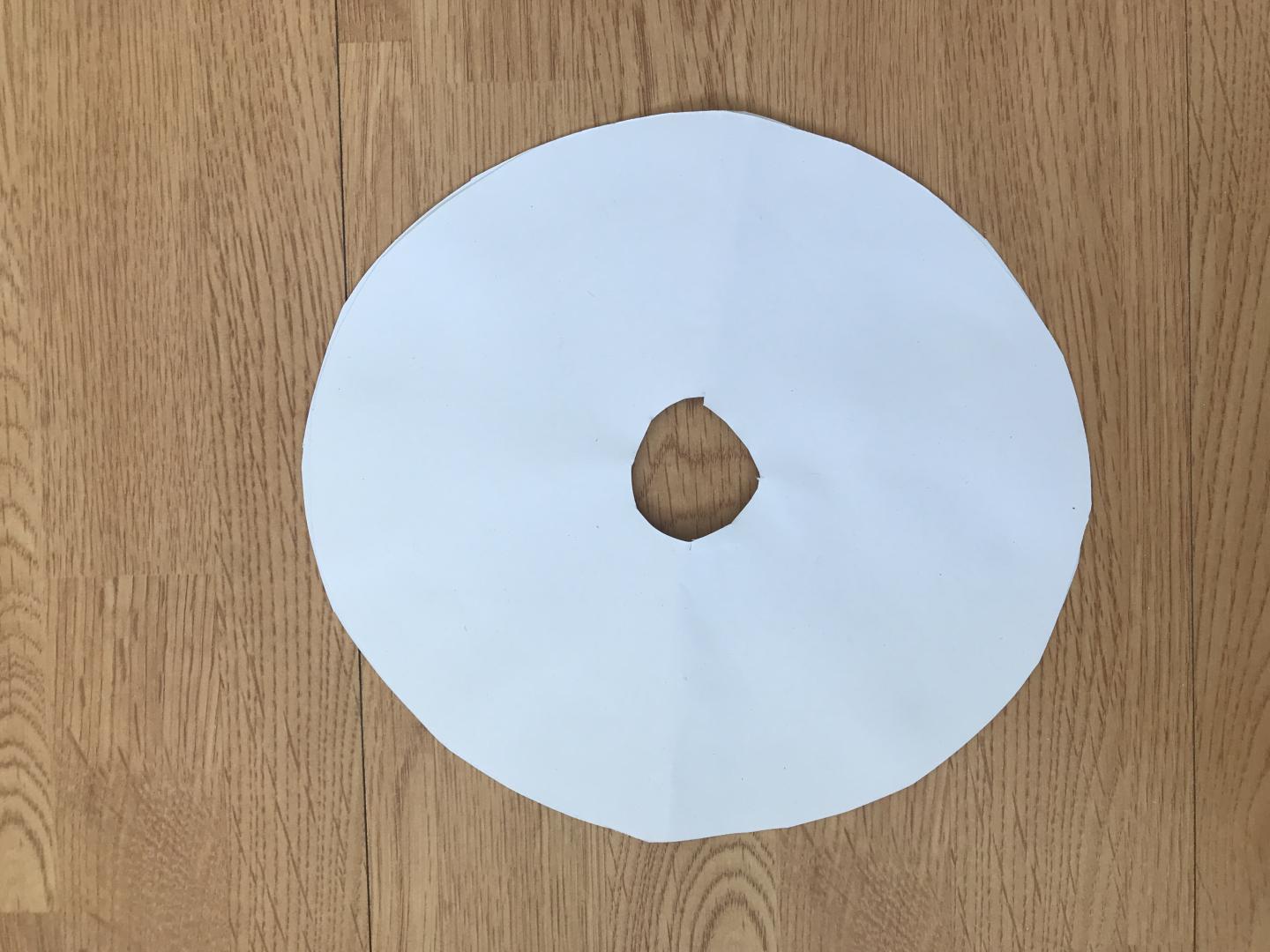 A circle cut from card with a smaller circle cut out from the middle. 