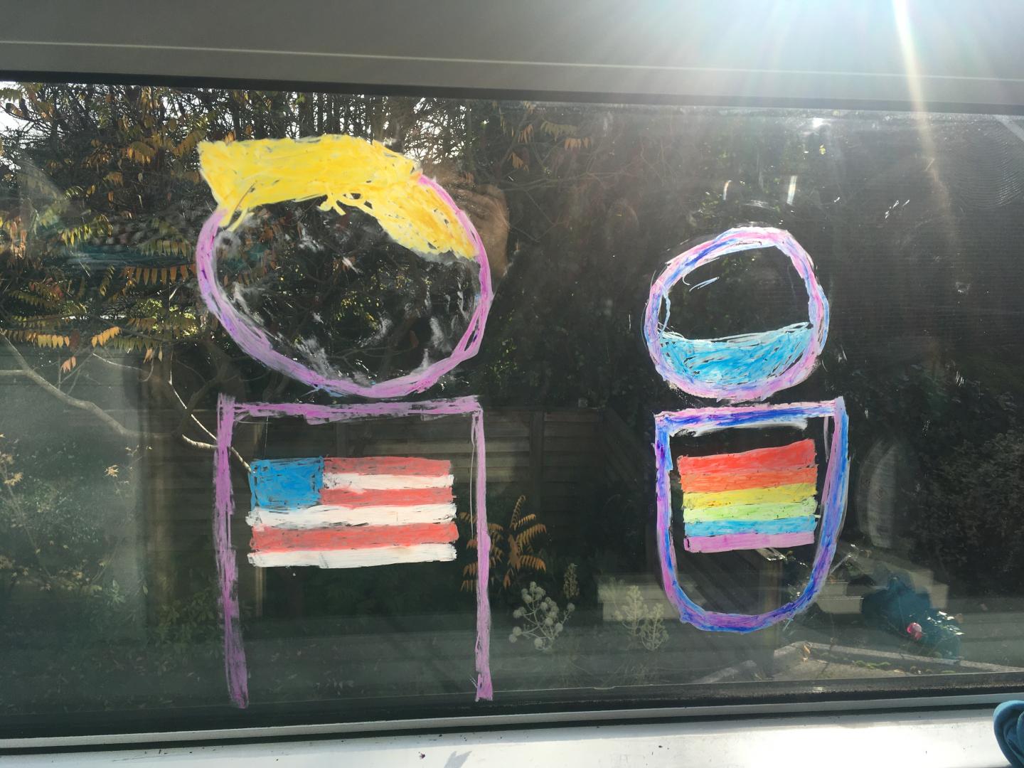 A drawing on a window of two bodies with two flags looking out into a garden