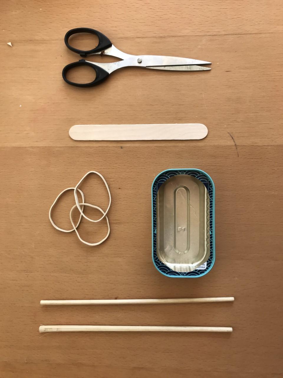 (Source of Lolly pop sticks Scissors Mackerel tin (ask a parent to cover the sharp edge or use a margarine tub) Elastic bands 2 chopsticks or old pencils picture)