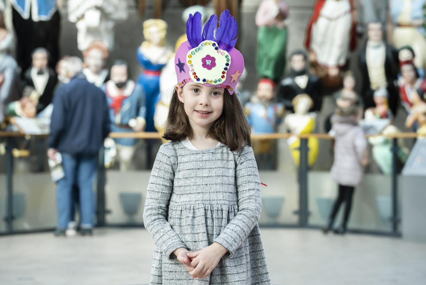 (source of a little girl wearing a paper crown with feathers picture)