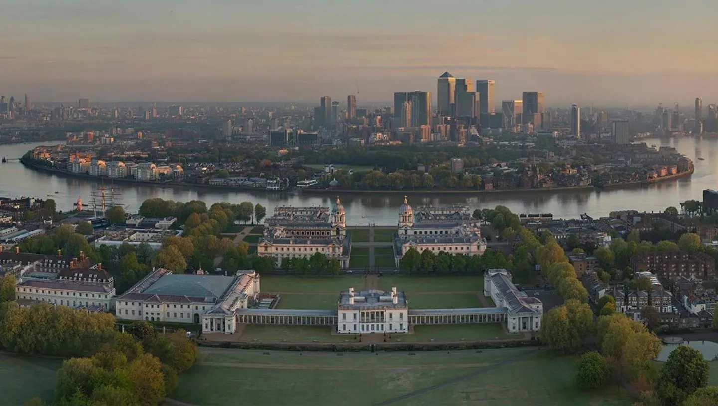 An aerial view of Greenwich and Canary Wharf at dusk.