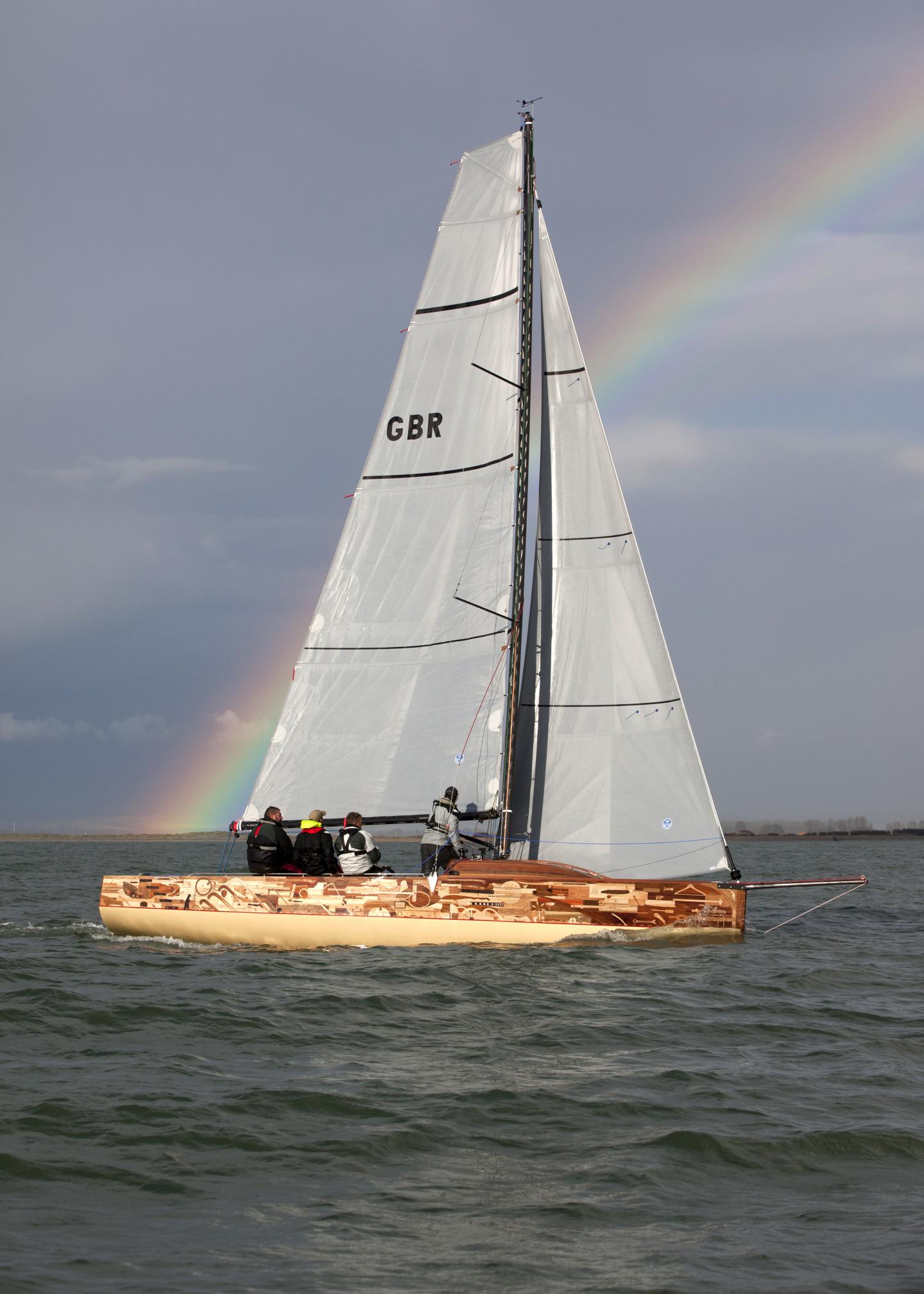 Sailing ship at sea with a rainbow