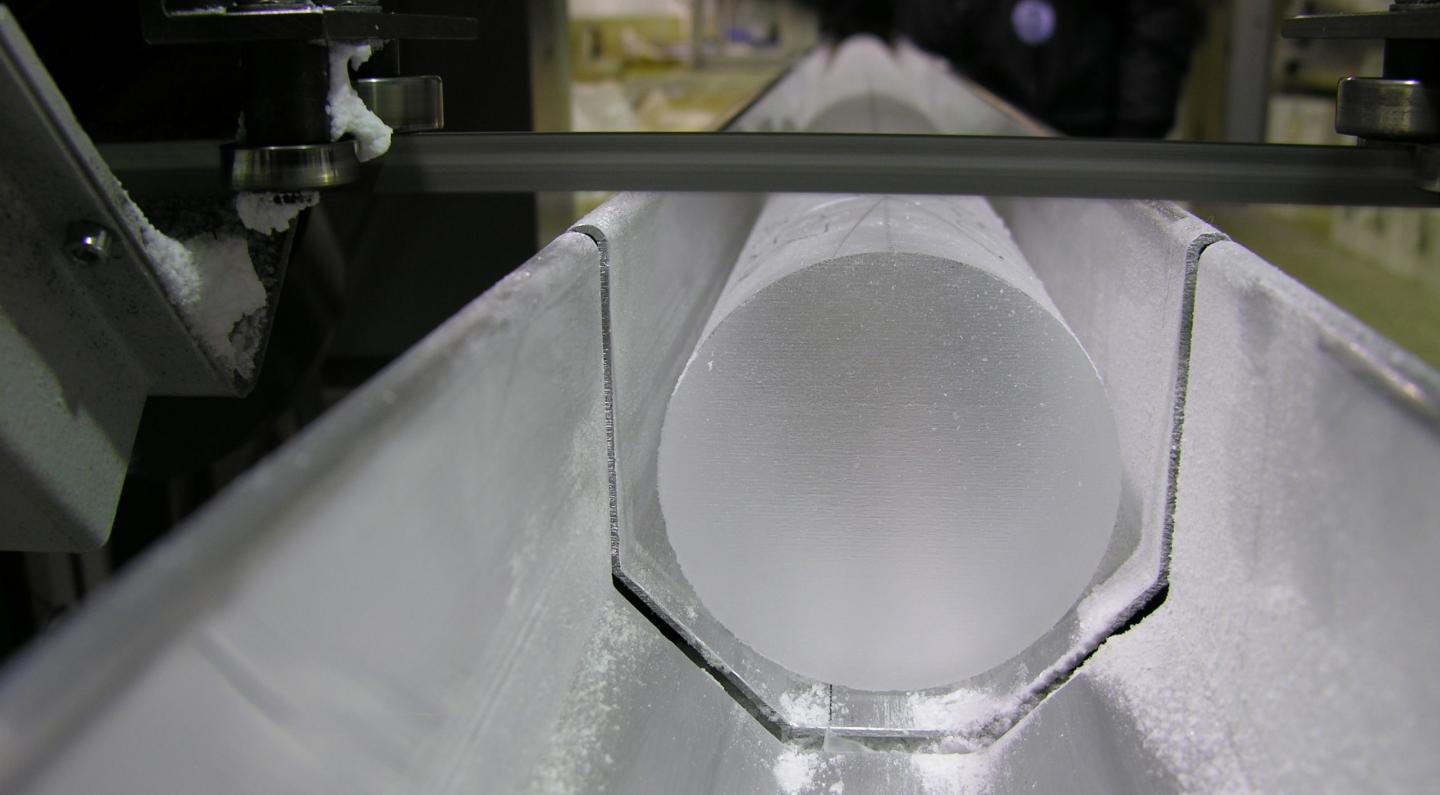 A sample of a drilled ice core in the process of being cut