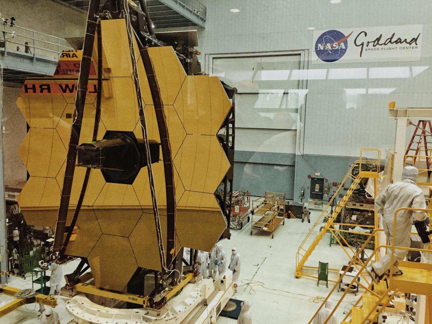 The James Webb Space Telescope surrounded by yellow hexagonal mirrors