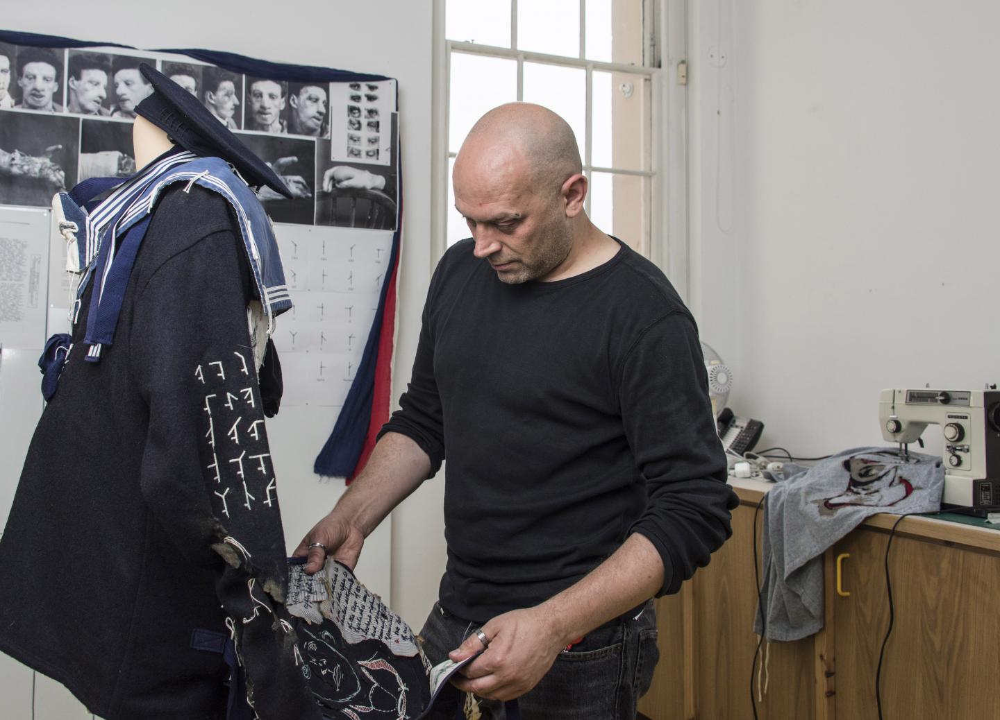 An artist works on a uniform