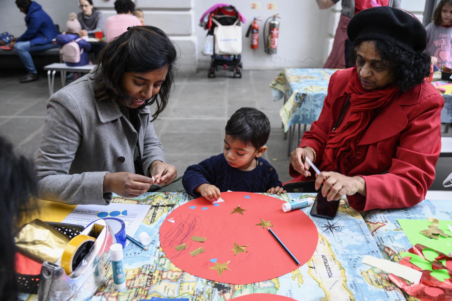 Family taking part in a craft workshop for Diwali.