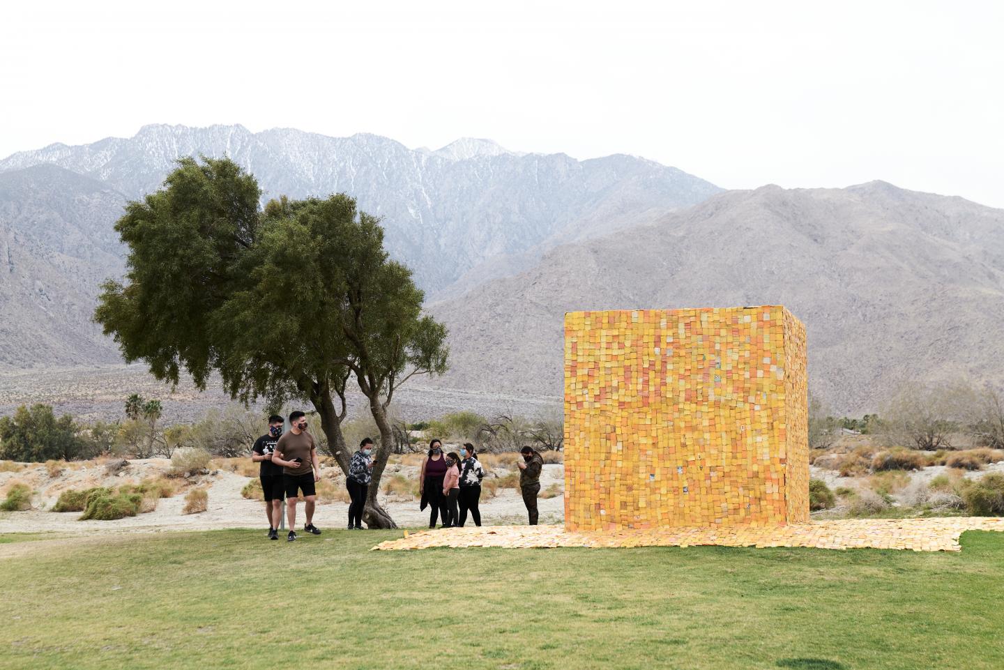 A yellow container in front of mountains