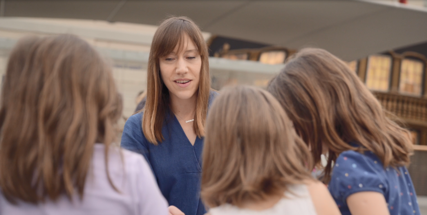 A woman talks to children at the National Maritime Museum