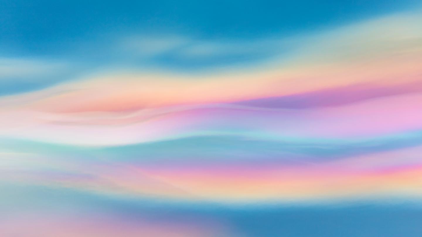 Blue, purple and orange iridescent clouds blur and streak