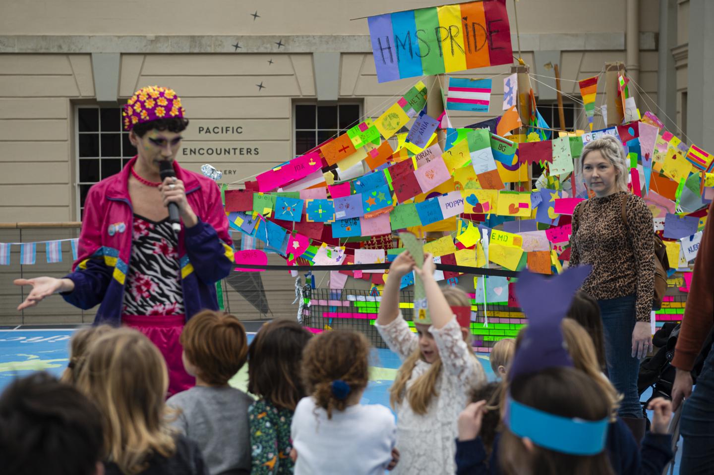 (Source of children with a freelancer celebrating HMS Pride Picture)