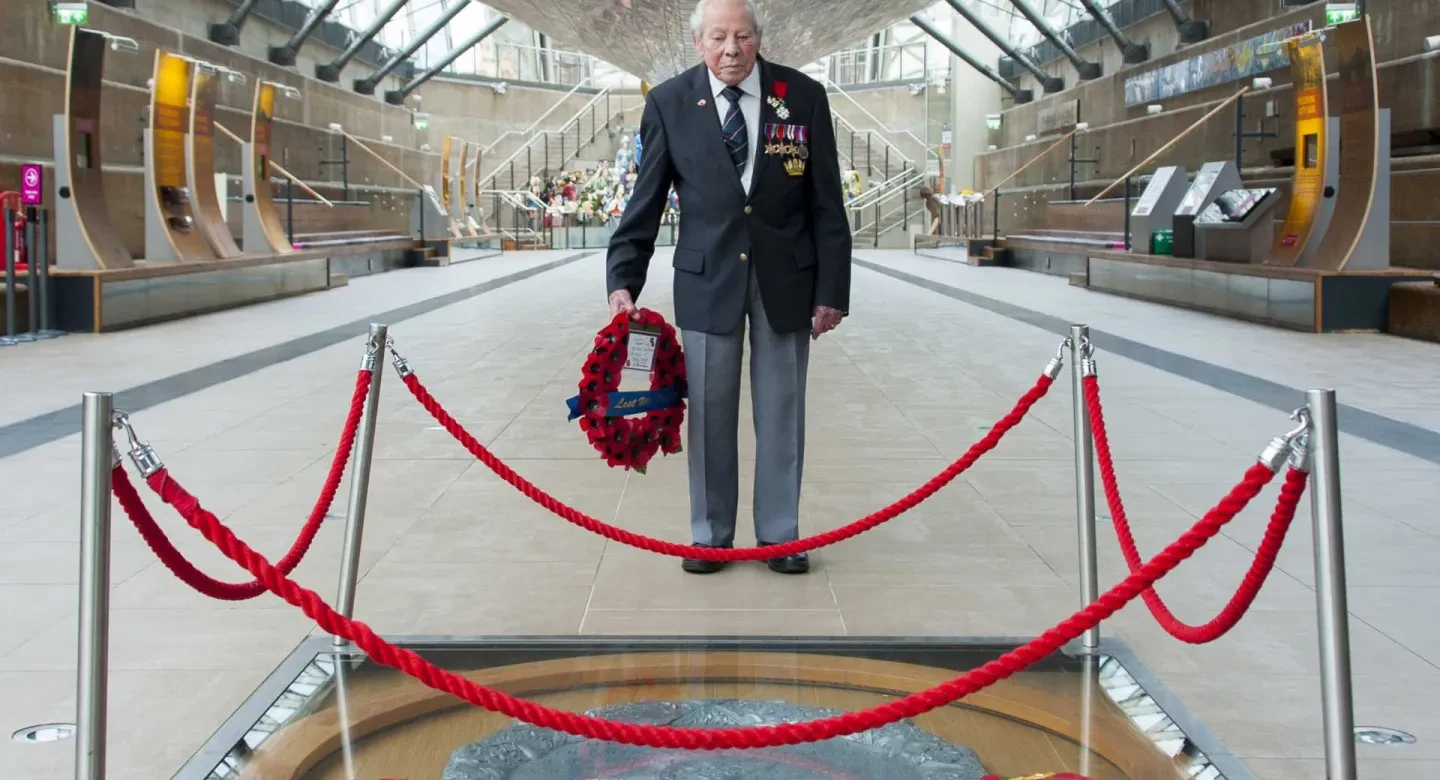 Second World War veteran Charles Roper Medhurst, 95, holds a poppy wreath during the Remembrance Day 2020 commemorations at Cutty Sark