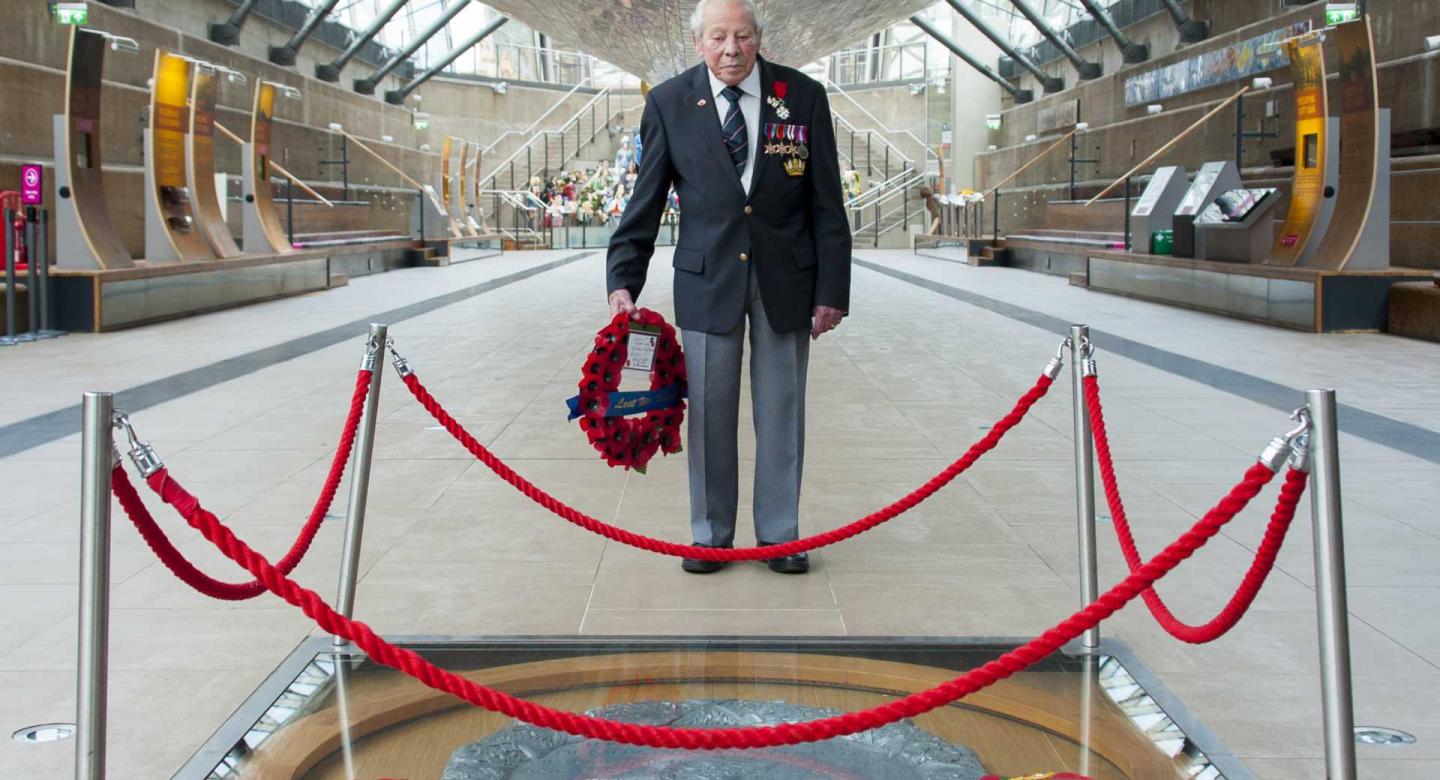 Second World War veteran Charles Roper Medhurst, 95, holds a poppy wreath during the Remembrance Day 2020 commemorations at Cutty Sark