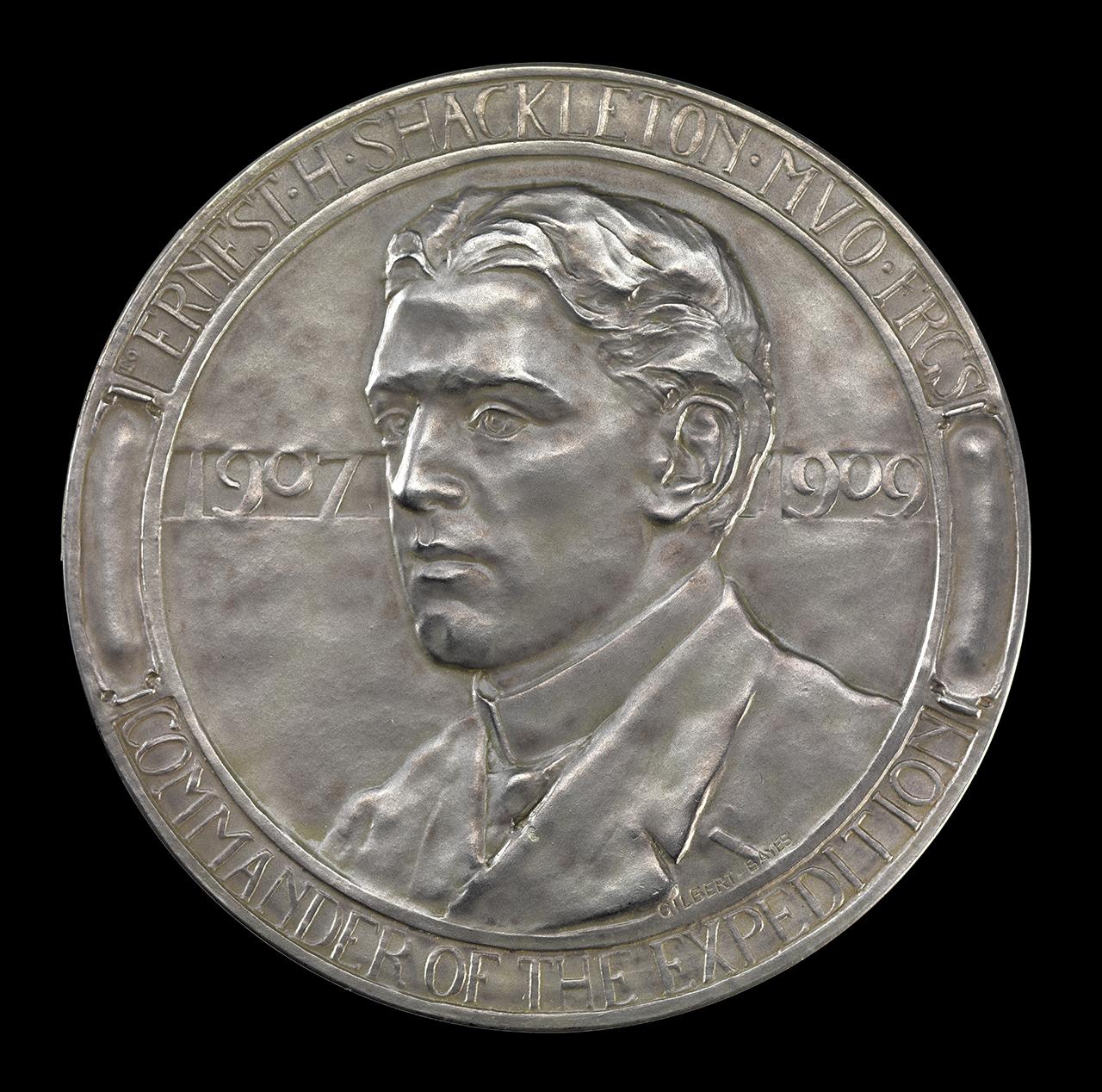 A commemorative silver medal showing Ernest Shackleton in profile