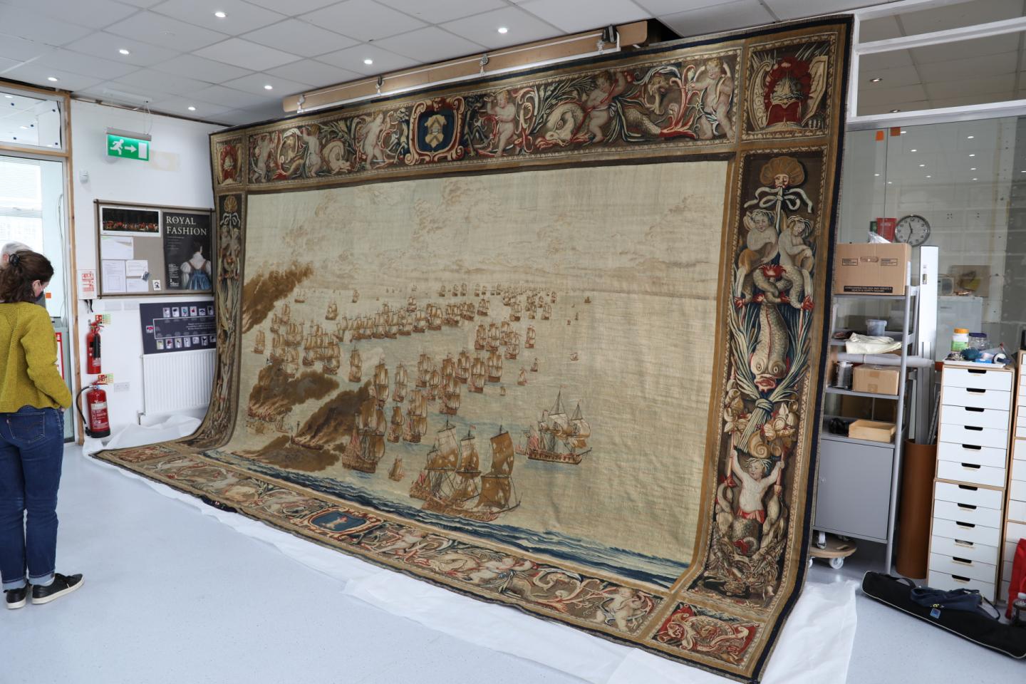 Naval tapestry hung up in a conservation studio