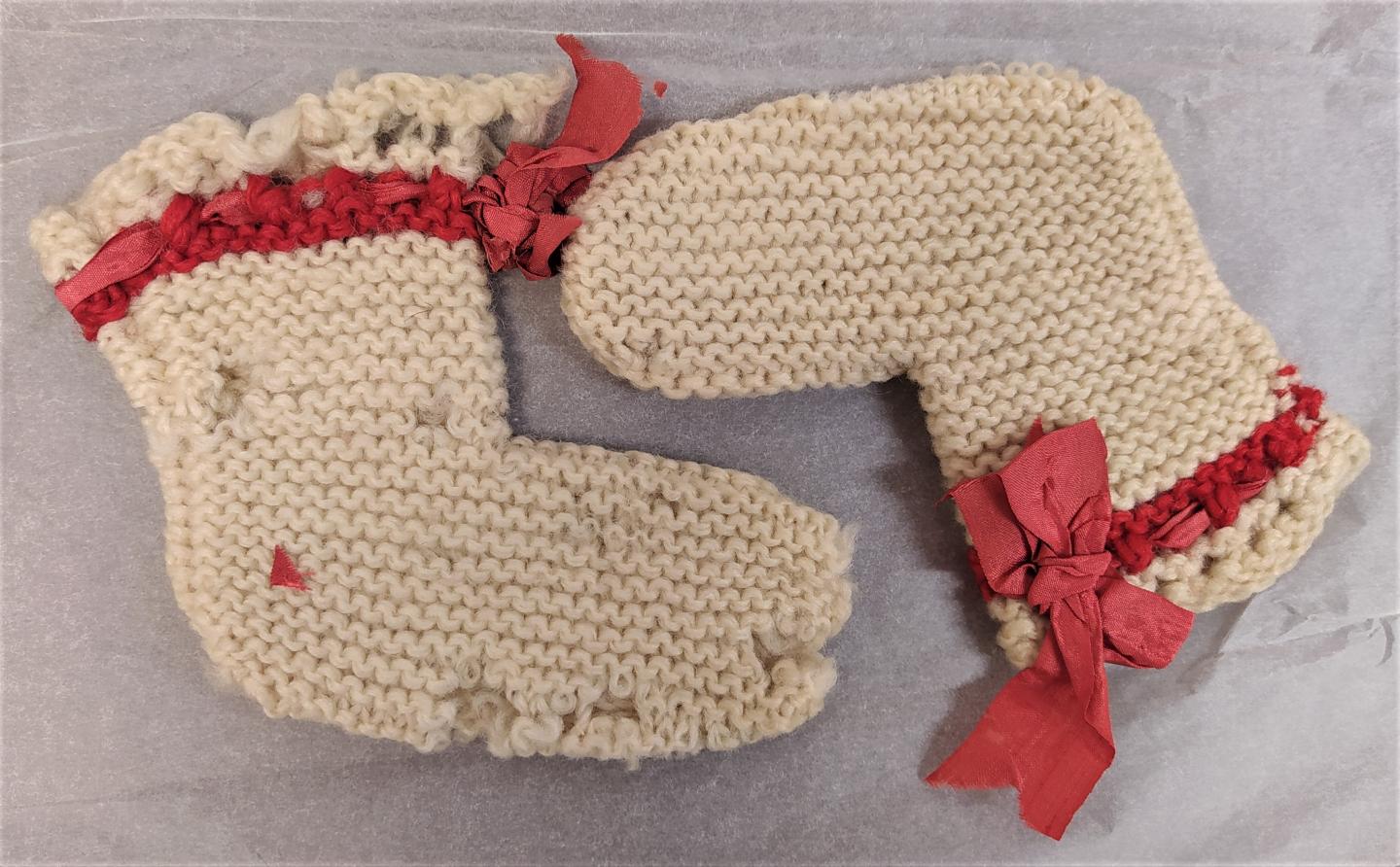 Pair of booties knitted by Hannah More for John MacGregor (RMG reference: MCG.2/1)