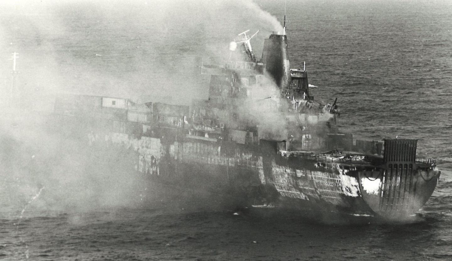 Black and white photograph of a ship on fire in the Falklands