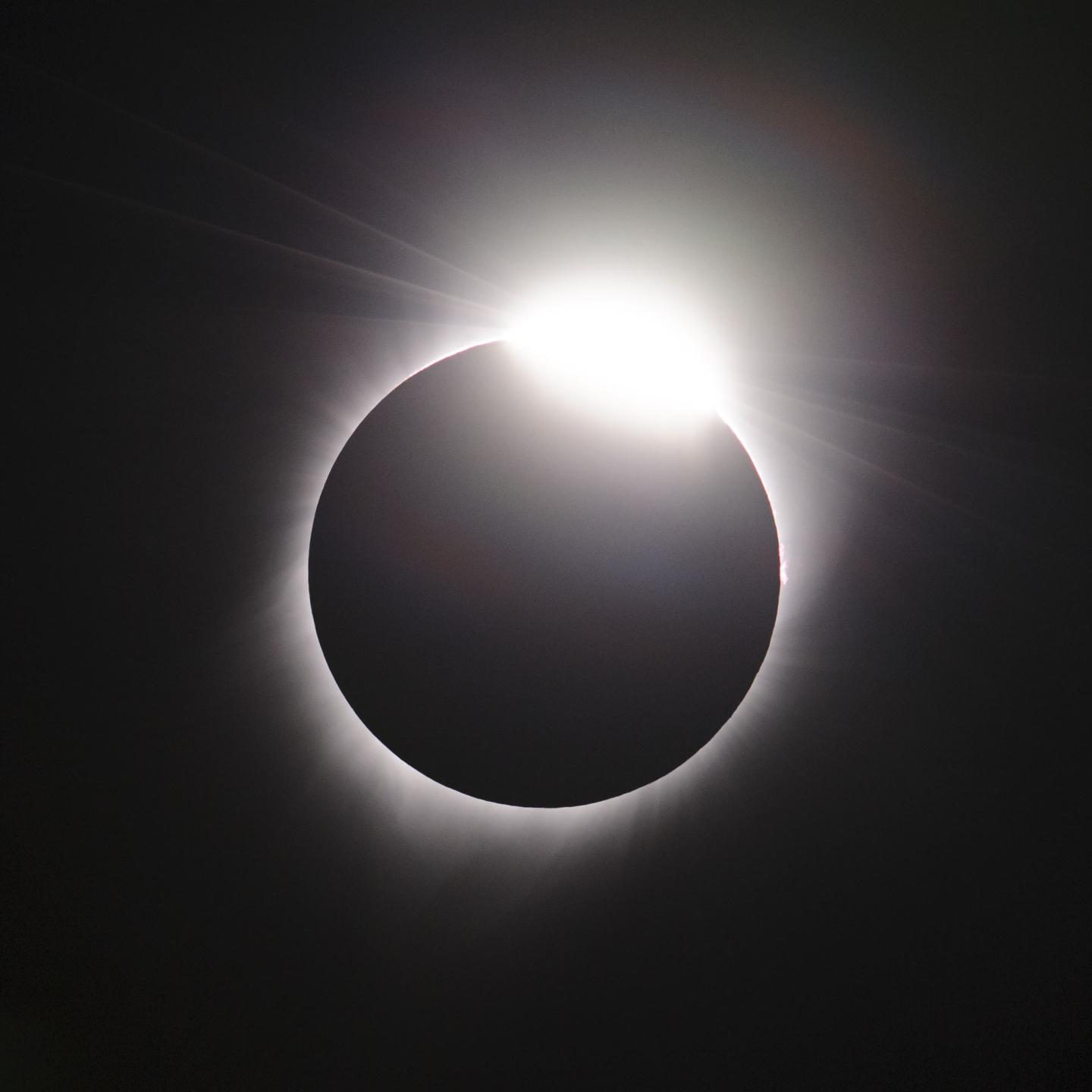 A picture taken during the 2017 solar eclipse in Oregon, showing a thin ring of light from the Sun around the Moon's shadow, with a bright 'diamond' of light in the top right