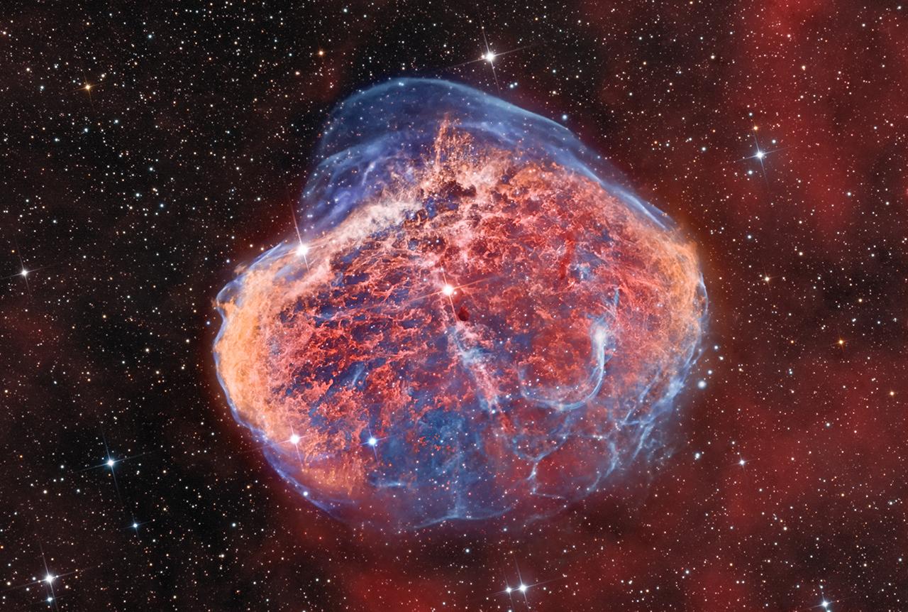 Red, orange and blue crescent nebula NGC 6888