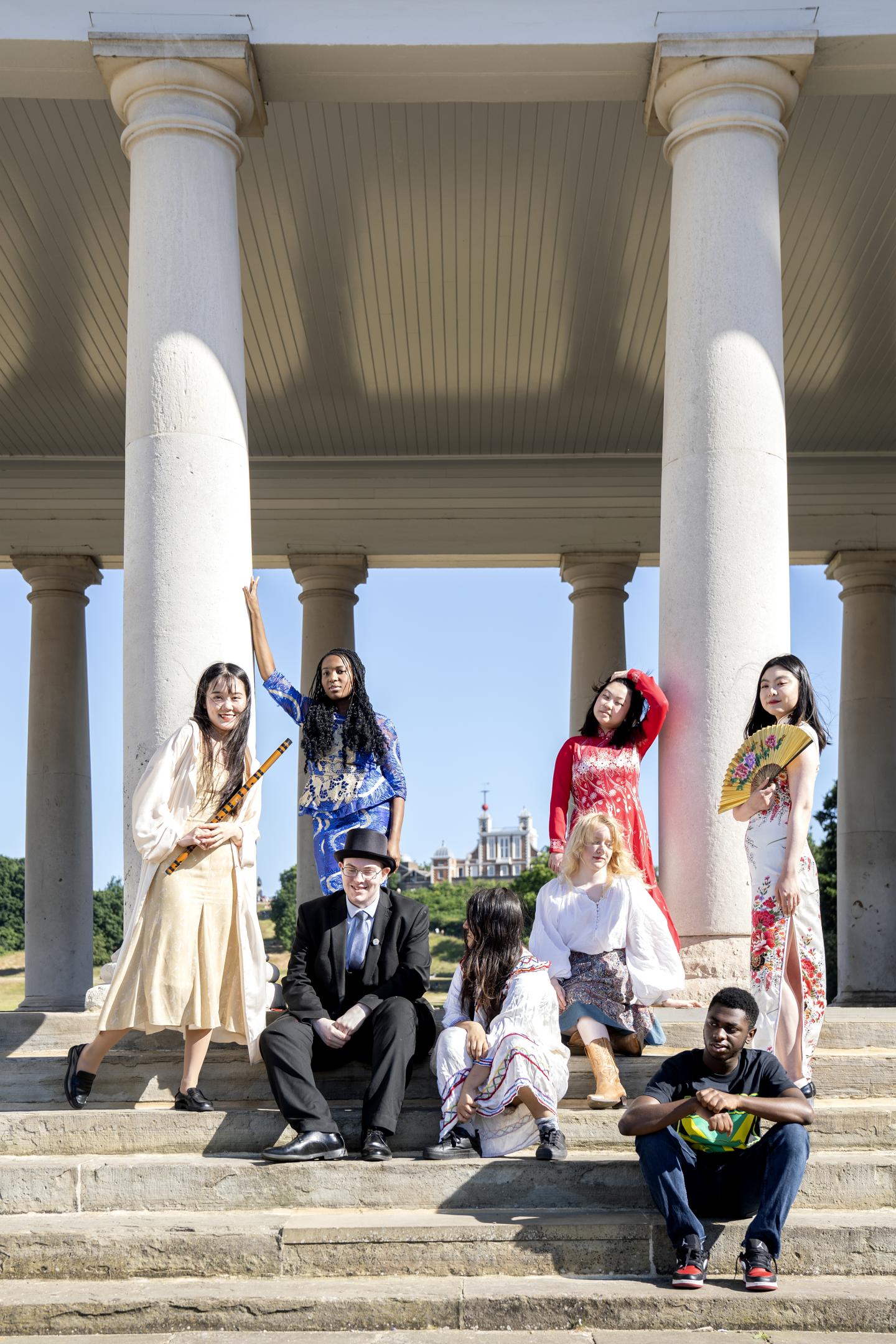 The youth collective pose on the colonnades with the Observatory behind them.
