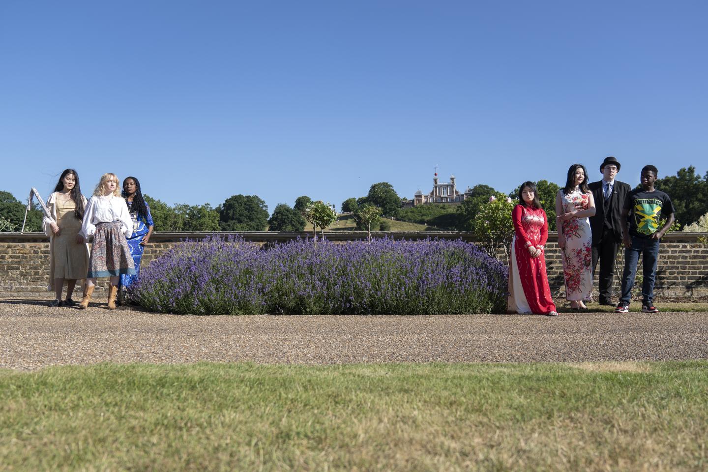 The Youth Collective pose in the Museum grounds with the observatory behind them.