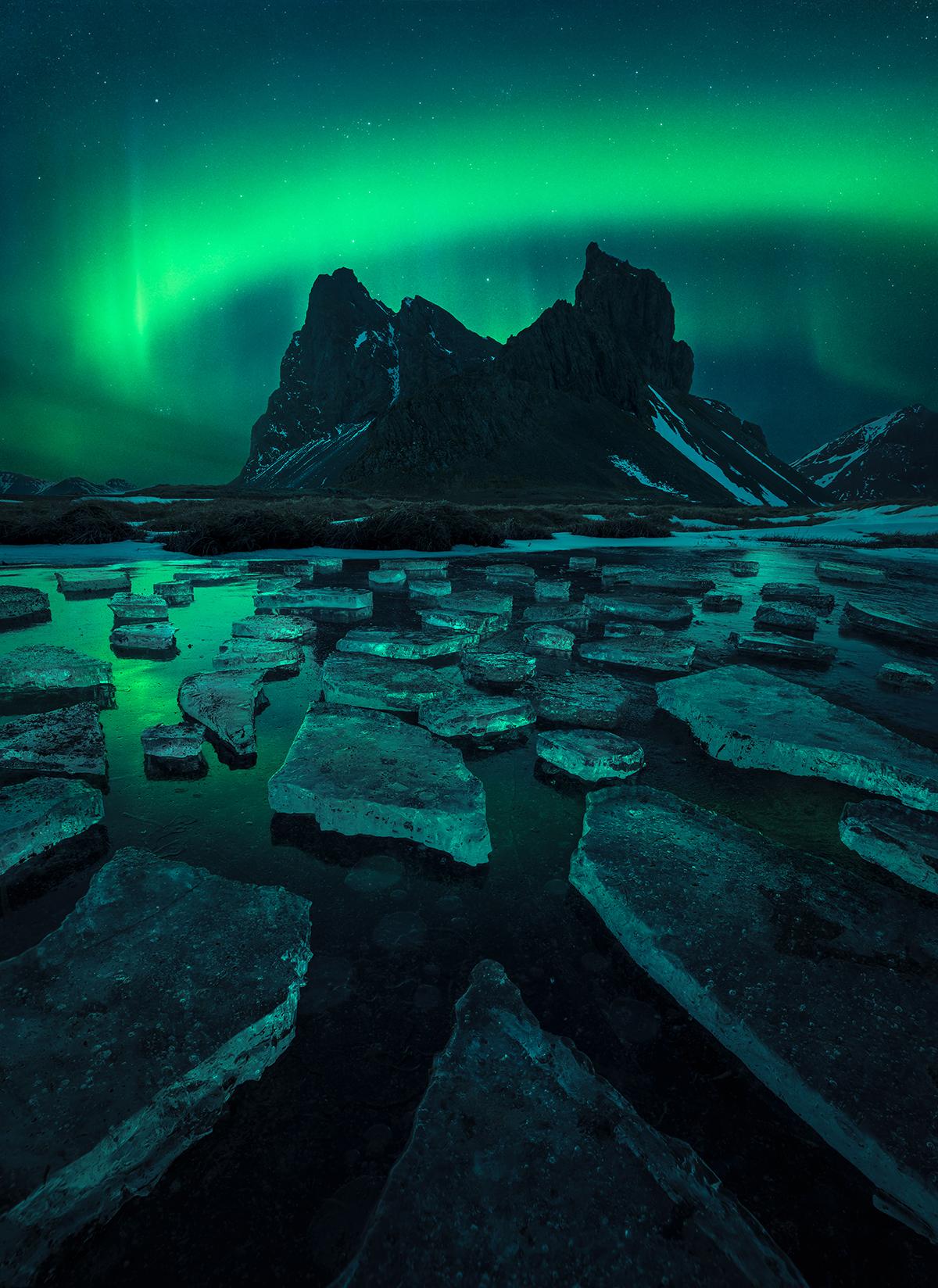 Northern lights over a rocky mountain in Iceland