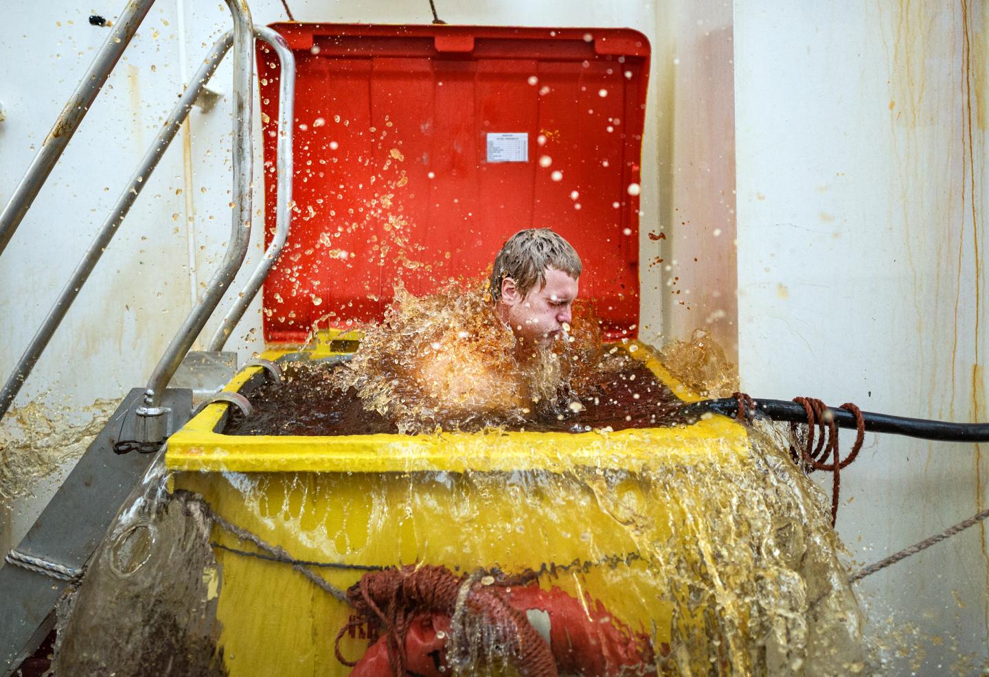 Man submerged in a large bin
