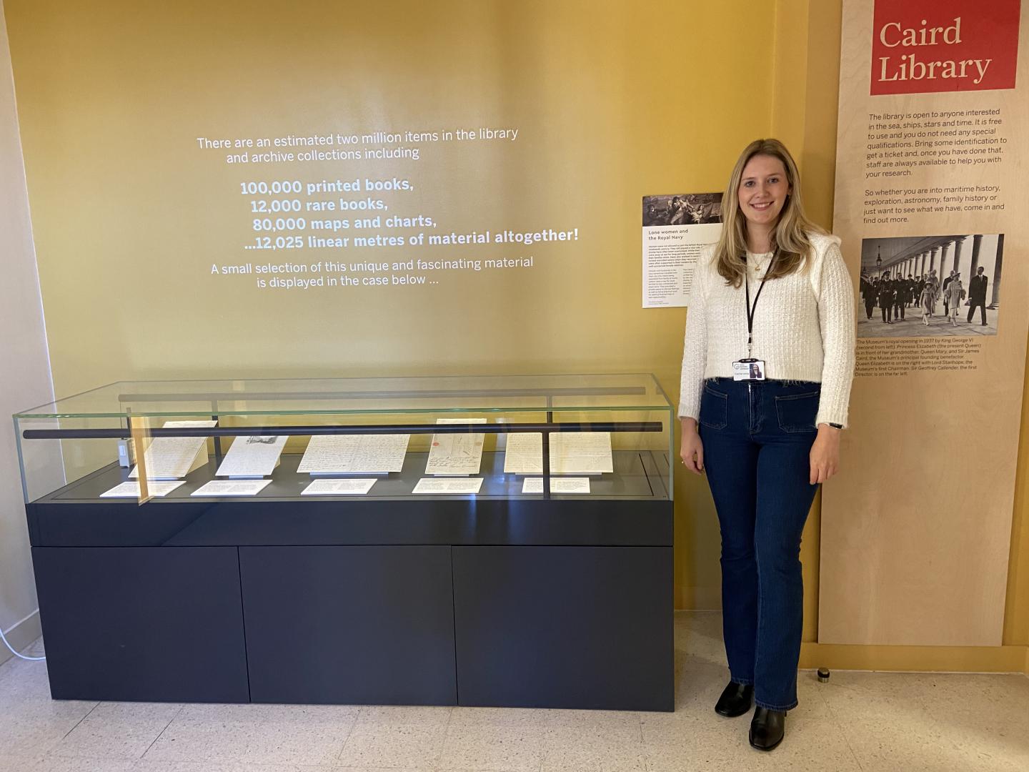 Carrie Long pictured by the Caird Library's display case