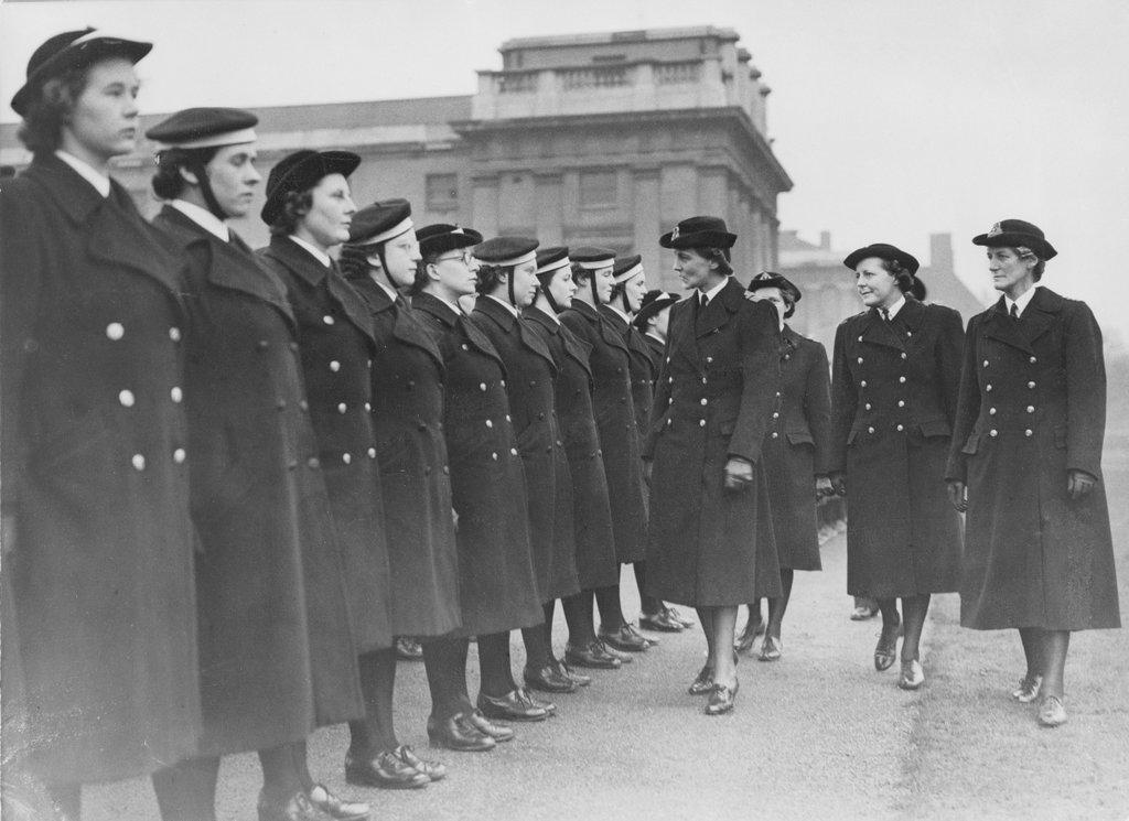 B&W photo of a line of Wrens being inspected by a other service women outside the maritime museum, greenwich
