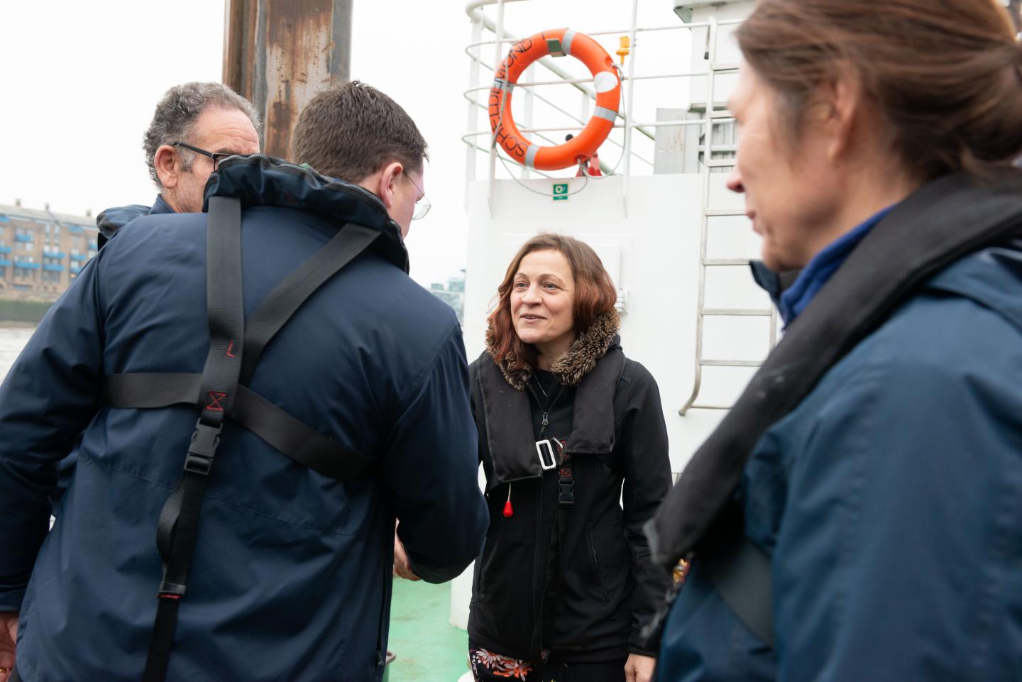 Cathryn Spain in discussion on a boat