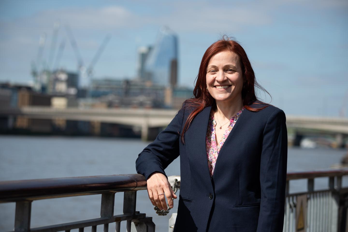 Cathryn Spain stands by the River Thames