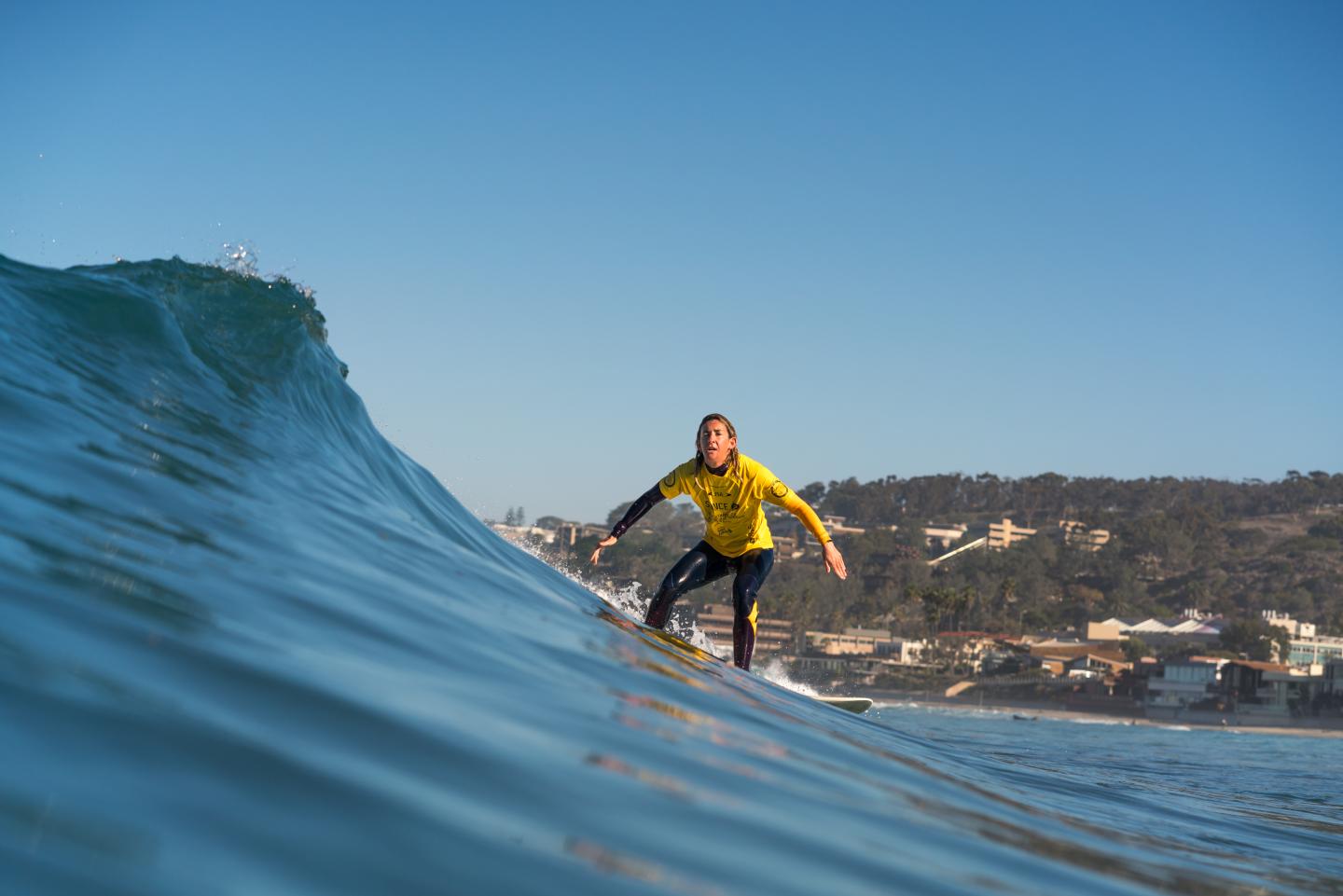 Melissa Reid surfing a wave in California