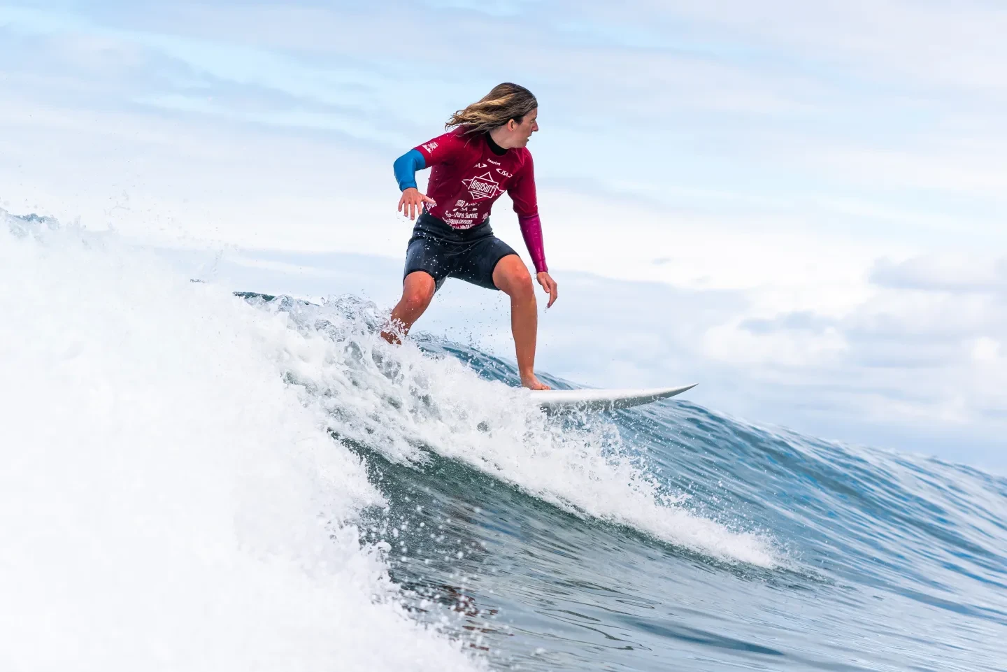 Melissa Reid surfing a wave in California
