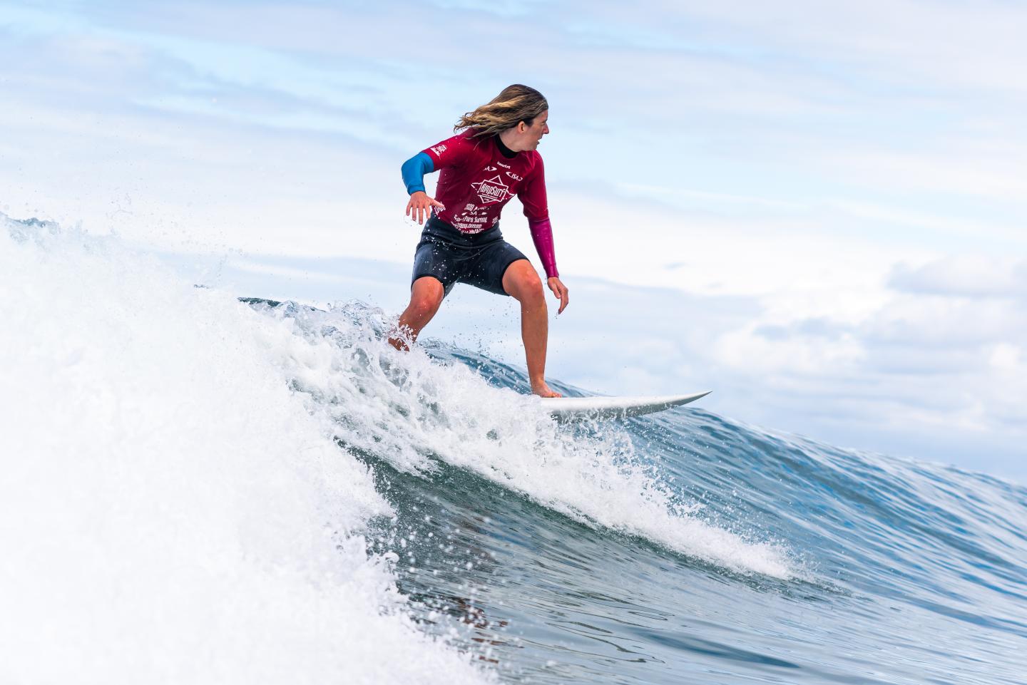 Melissa Reid surfing a wave in California