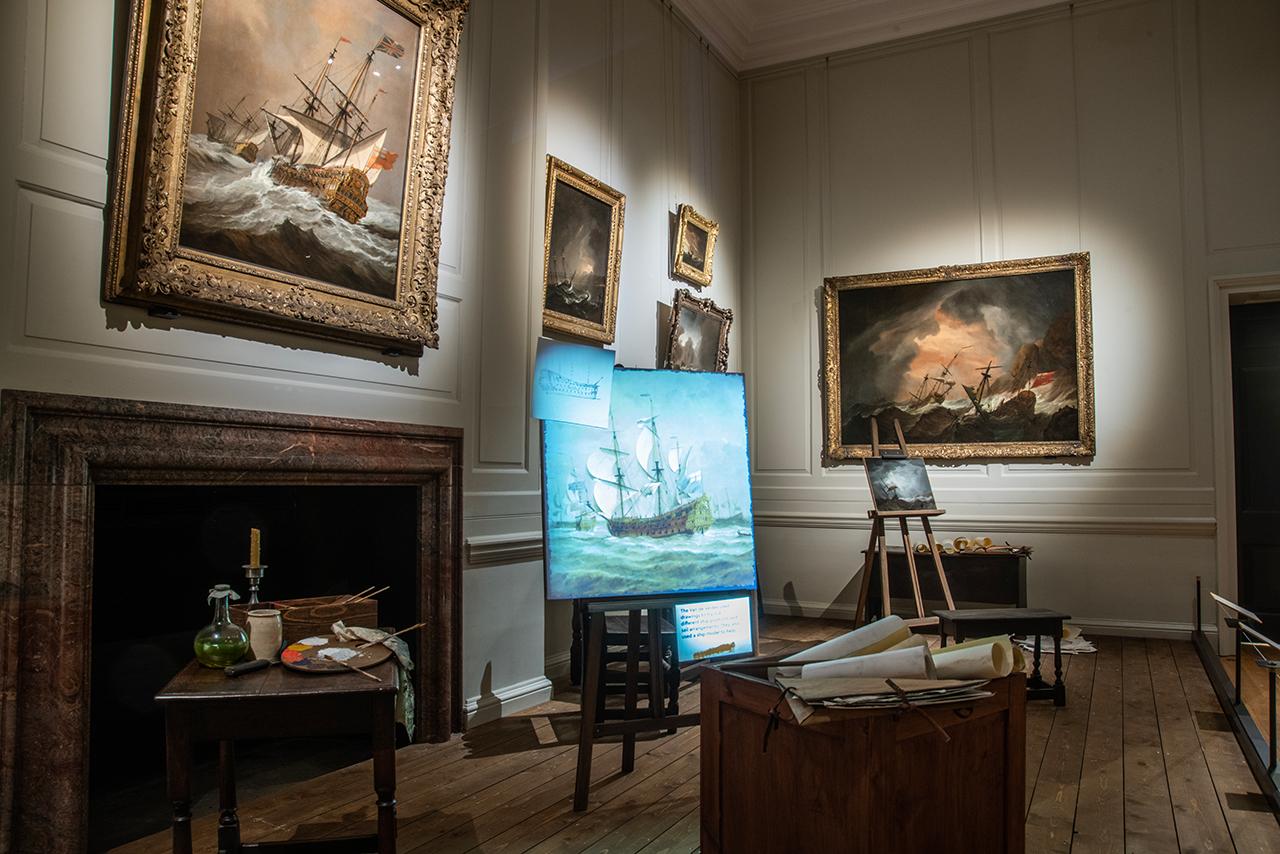 An interior shot of art exhibition The Van de Veldes: Greenwich, Art and the Sea at the Queen's House, showing an evocation of a 17th century artist studio