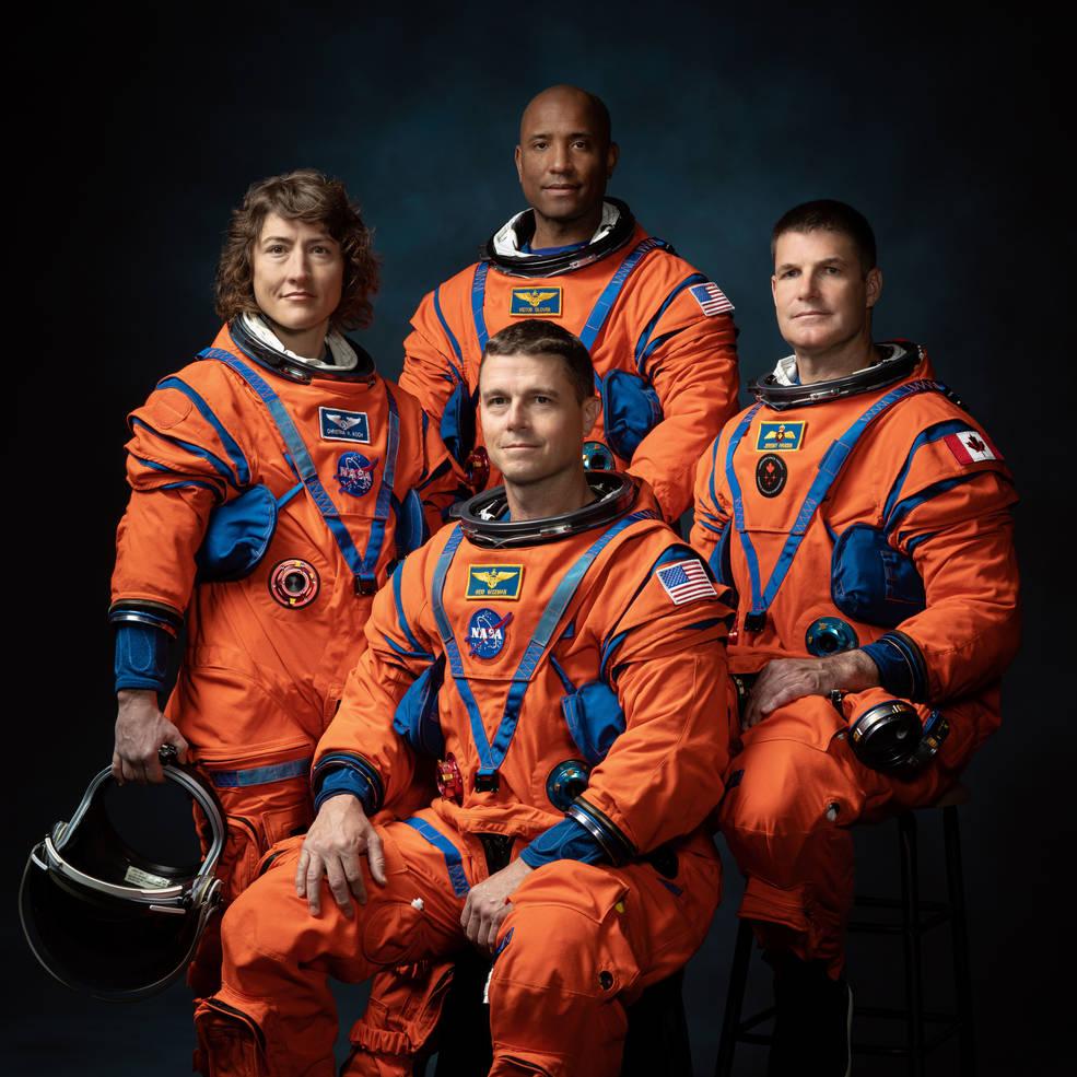 Image of 4 astronauts in orange spacesuits