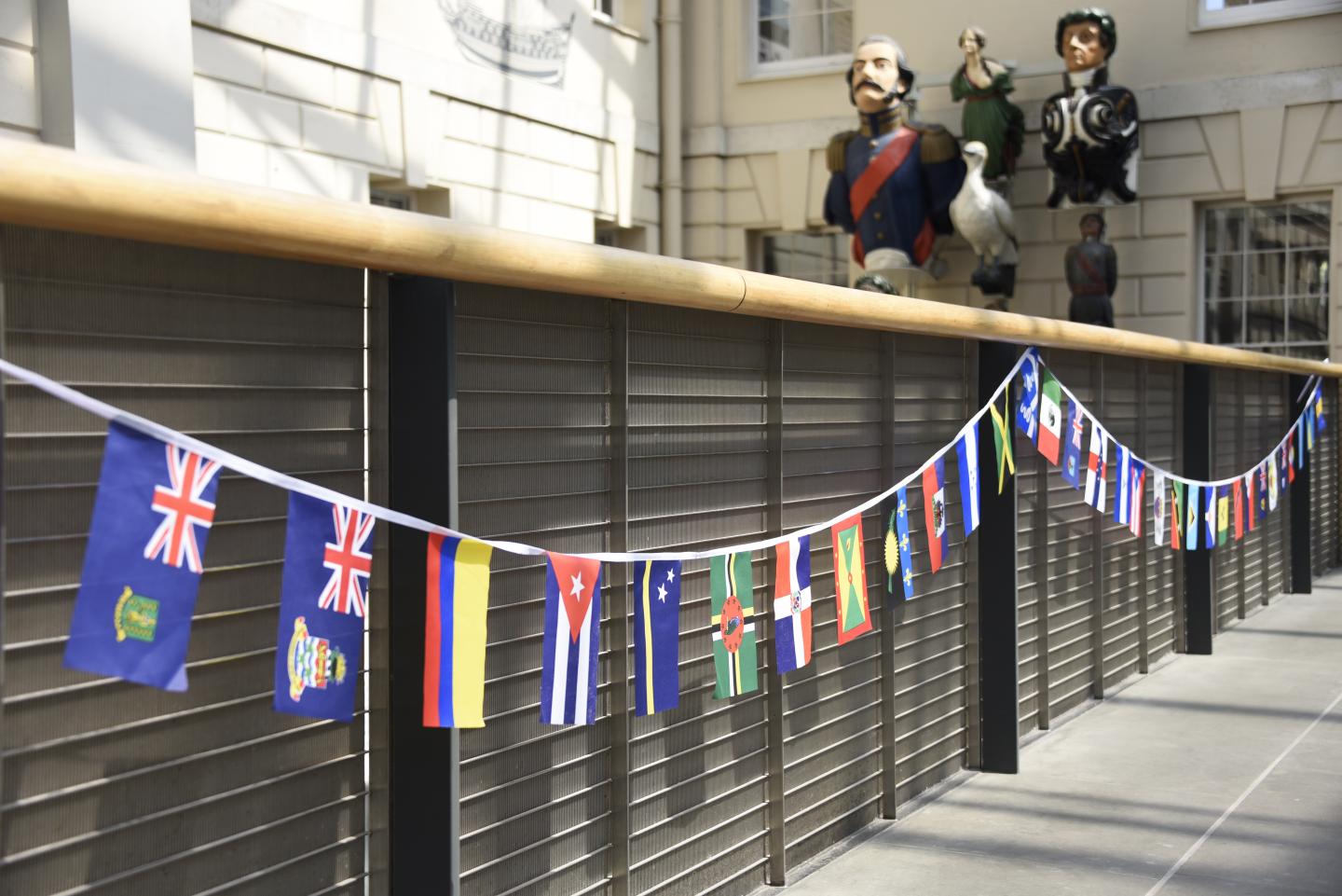 The image shows a banner of flags belonging to Caribbean countries.