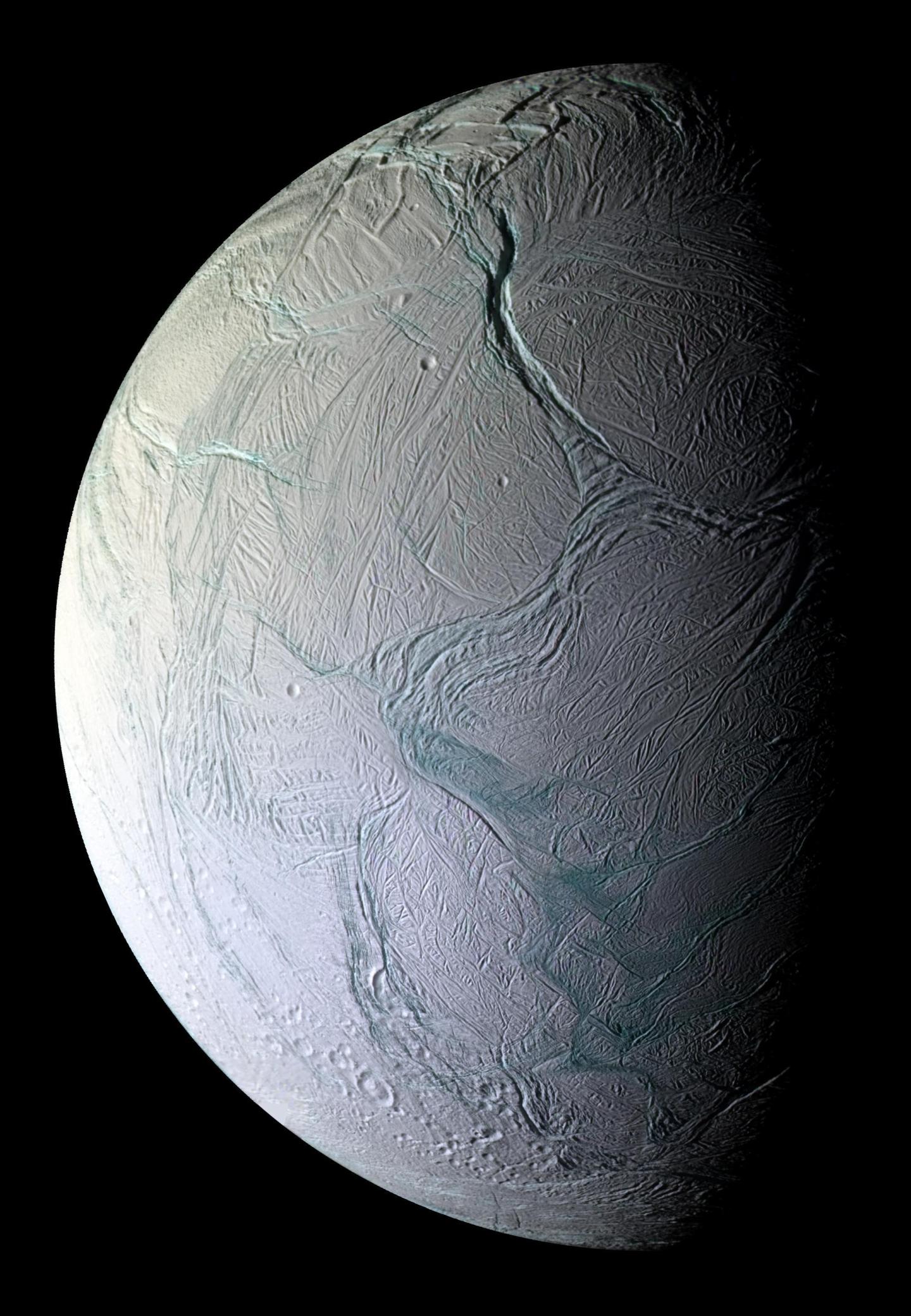 An image of the moon Enceladus, with a cracked icy surface. 