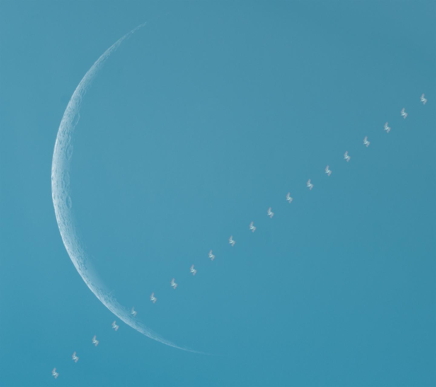 International Space Station passing in front of the Moon