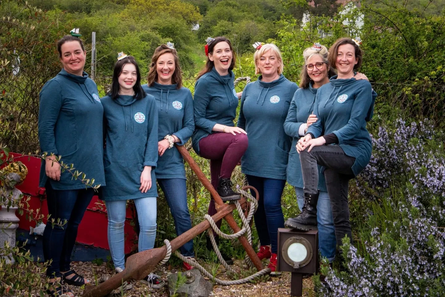 Shanty group, The Silver Darlings, stood rural outdoors with ship items 