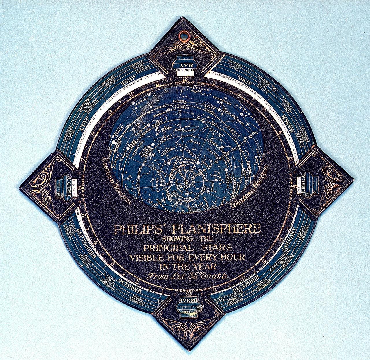 A planisphere which is a circular shape with a smaller crescent shape within it. Forming the other half of the crescent is a star map showing the constellations